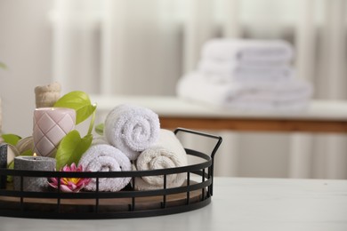 Photo of Composition with different spa products and burning candles on white table indoors, space for text