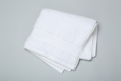 White terry towel on light grey background, top view