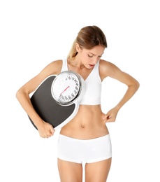 Photo of Young woman holding bathroom scales on white background. Weight loss diet
