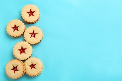 Photo of Traditional Christmas Linzer cookies with sweet jam on color background, top view