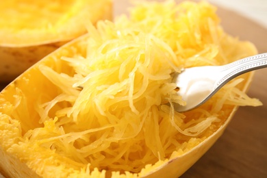 Photo of Tasty cooked spaghetti squash and fork, closeup