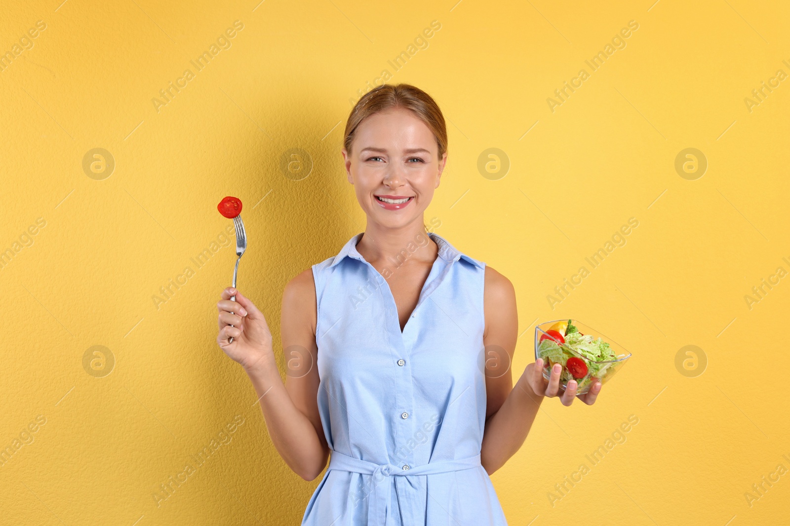 Photo of Slim woman with salad on color background. Healthy diet
