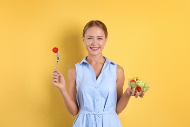 Slim woman with salad on color background. Healthy diet