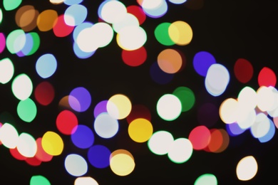 Photo of Beautiful colorful lights on dark background. Bokeh effect