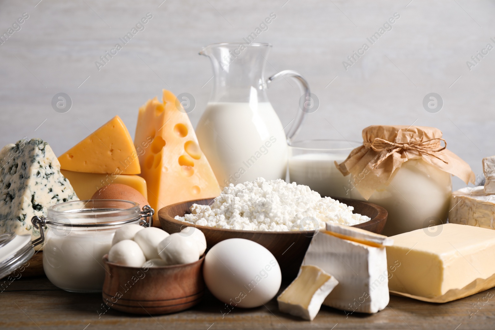 Photo of Different delicious dairy products on wooden table