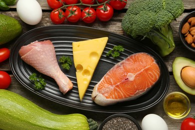 Photo of Flat lay composition with keto diet products on wooden table