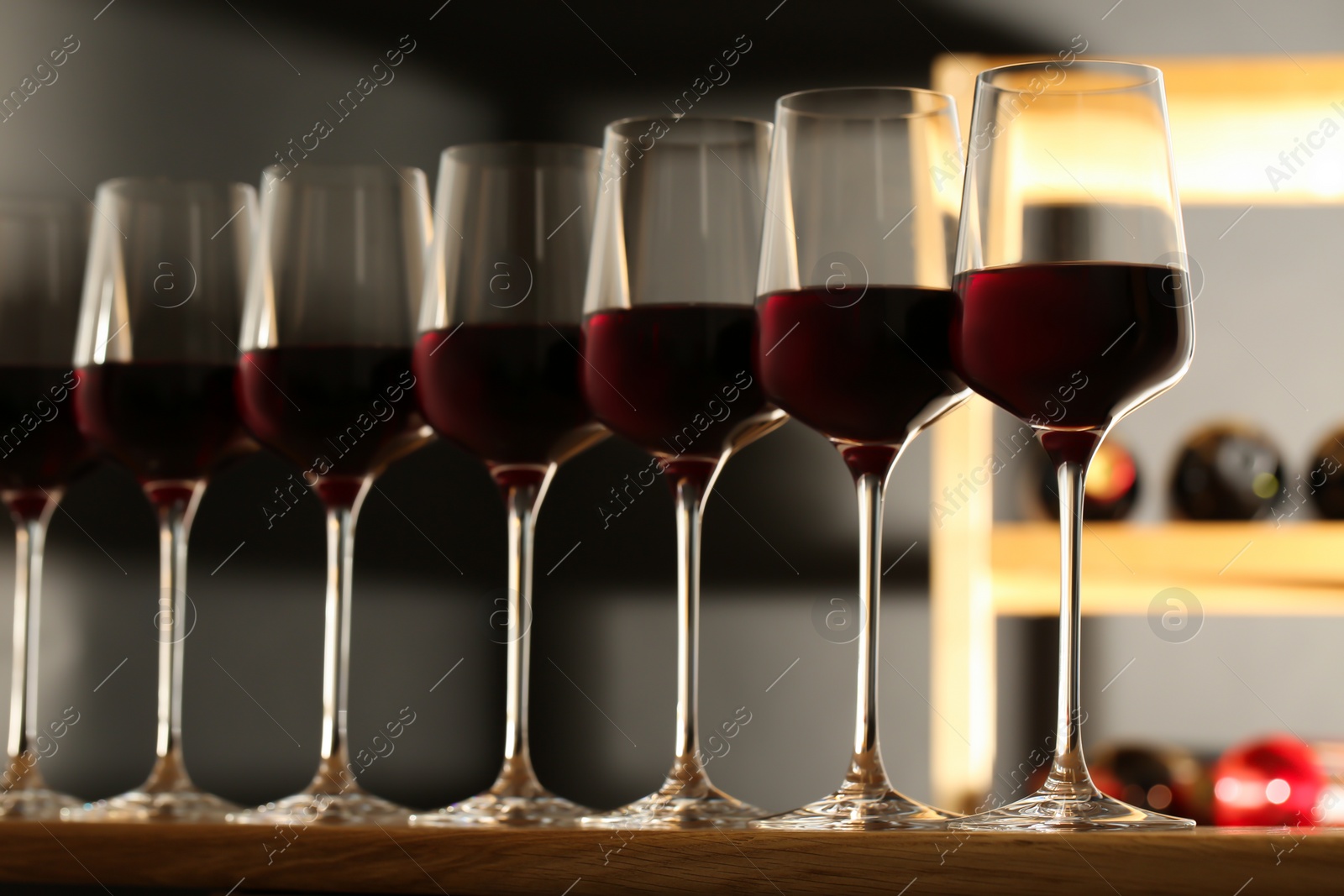 Photo of Glasses of red wine in cellar. Expensive drink