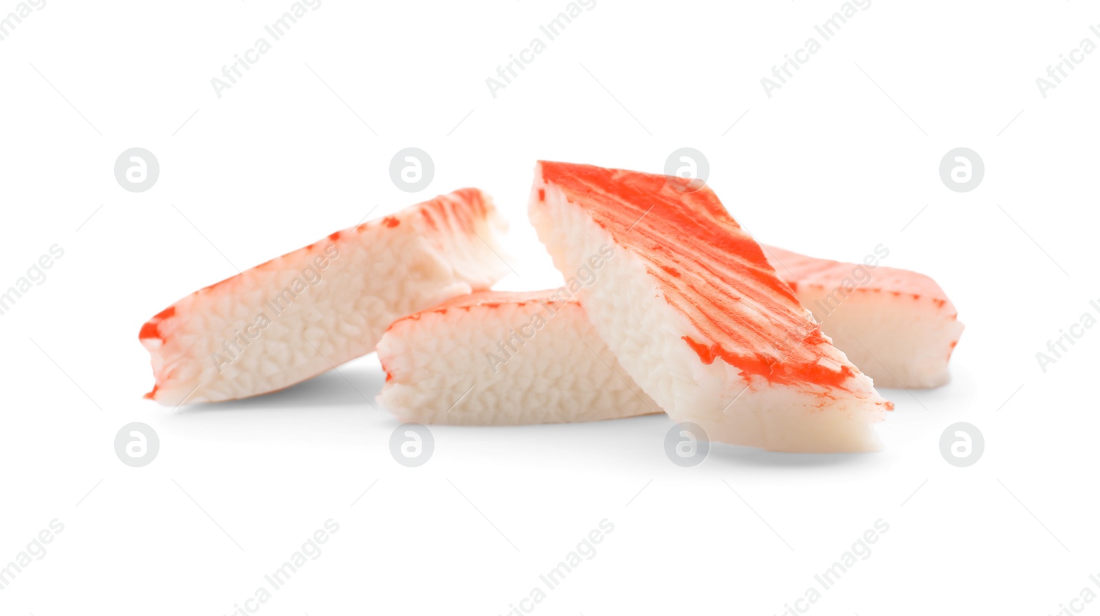 Photo of Pieces of crab stick isolated on white