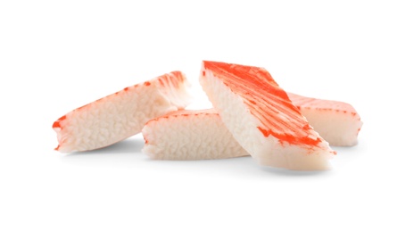 Photo of Pieces of crab stick isolated on white