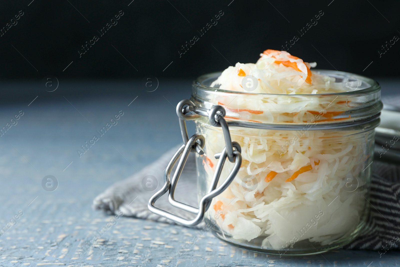 Photo of Tasty homemade fermented cabbage on wooden table, closeup