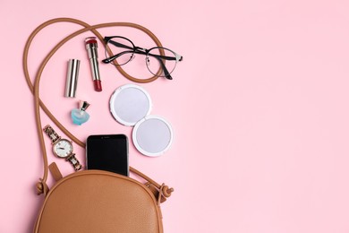 Photo of Stylish woman's bag with smartphone and accessories on pink background, flat lay. Space for text