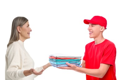 Image of Dry-cleaning delivery. Courier giving folded clothes to woman on white background