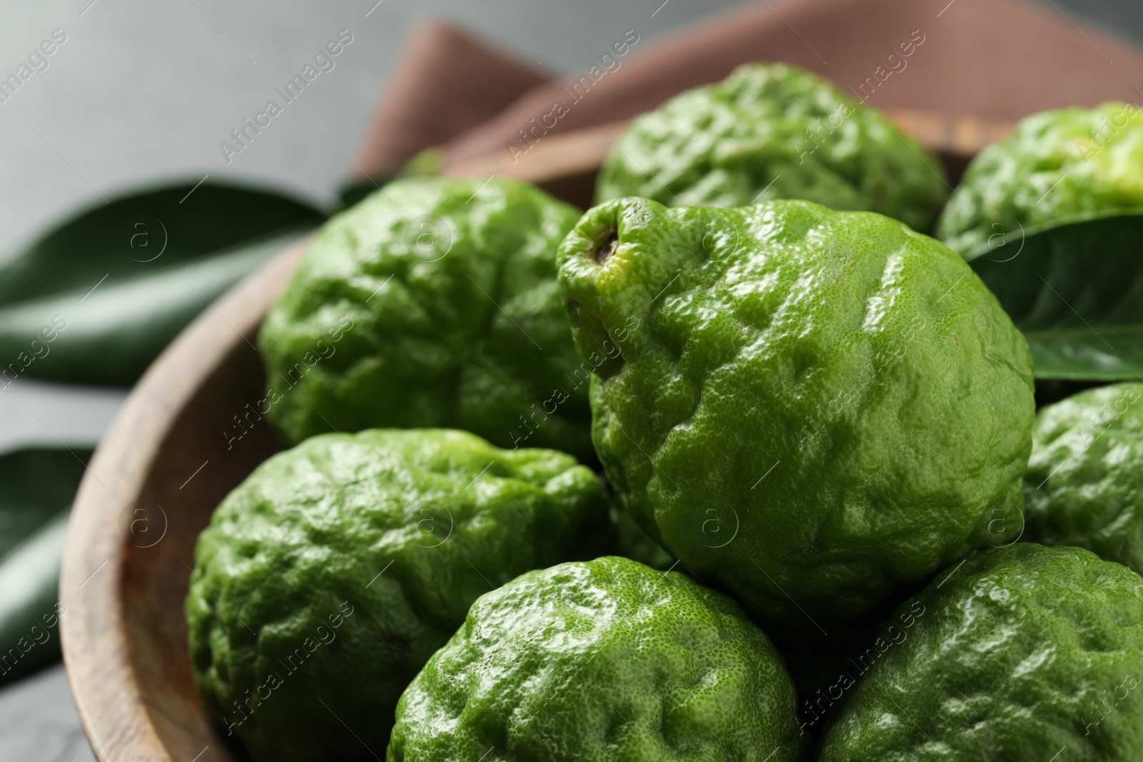 Photo of Fresh ripe bergamot fruits in bowl, closeup