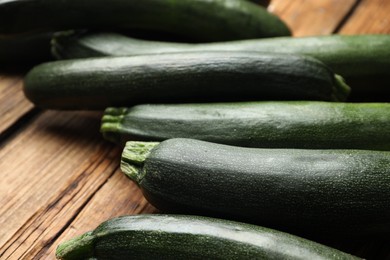 Green ripe zucchinis on wooden table, closeup