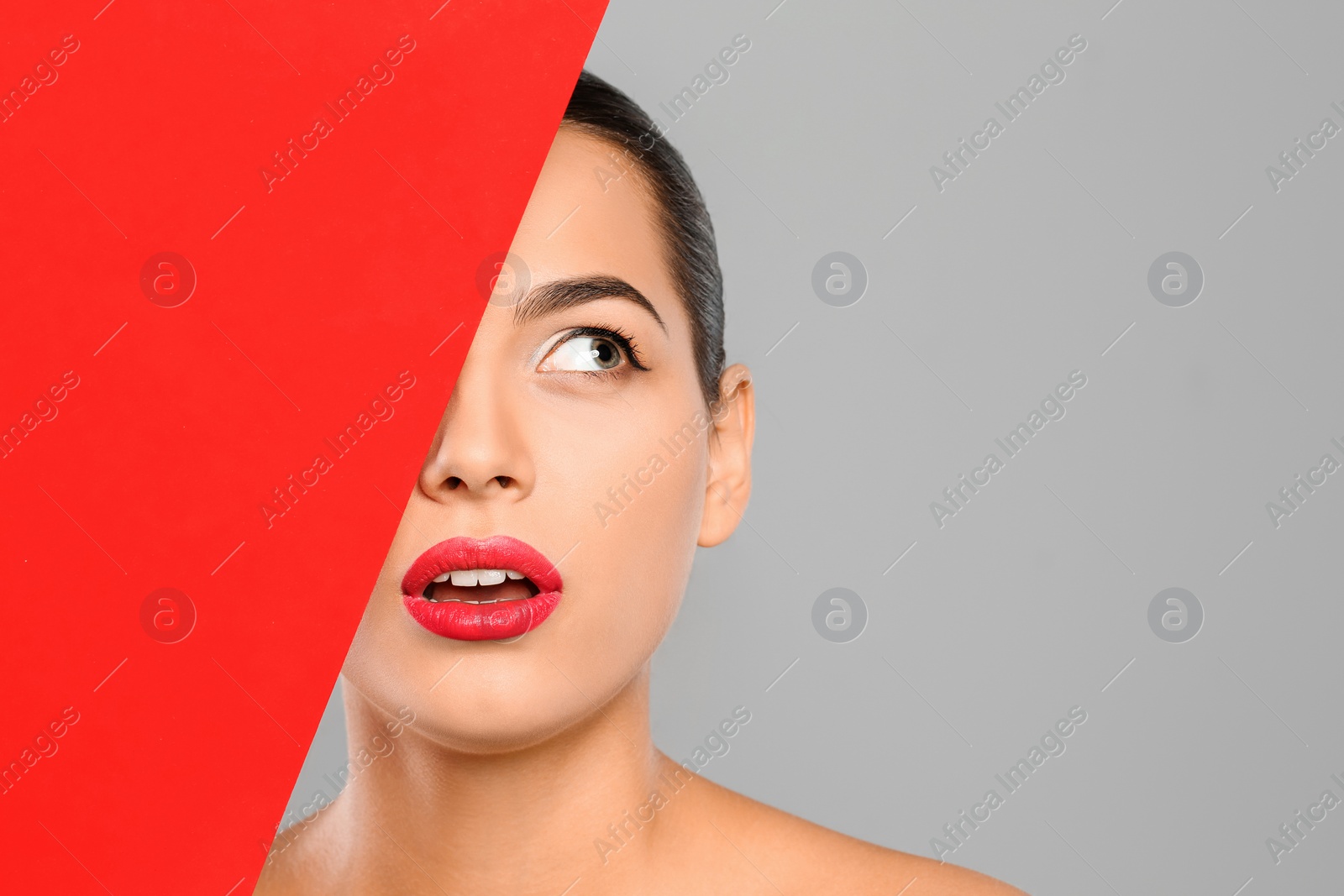 Photo of Young woman wearing beautiful lipstick on color background. Space for text