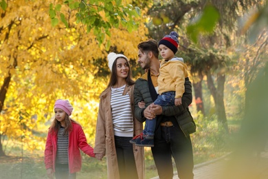 Happy family with children together in park. Autumn walk