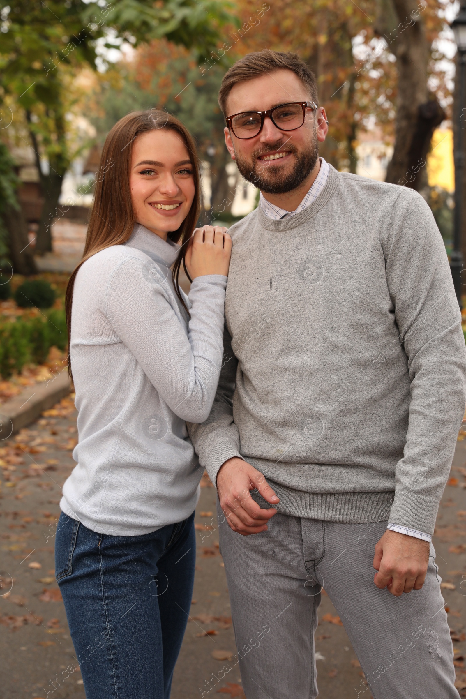 Photo of Happy couple wearing stylish clothes in autumn park