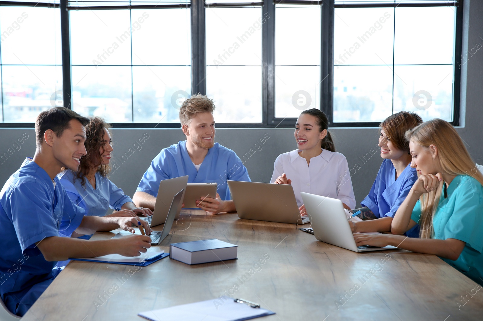 Photo of Group of smart medical students with gadgets in college