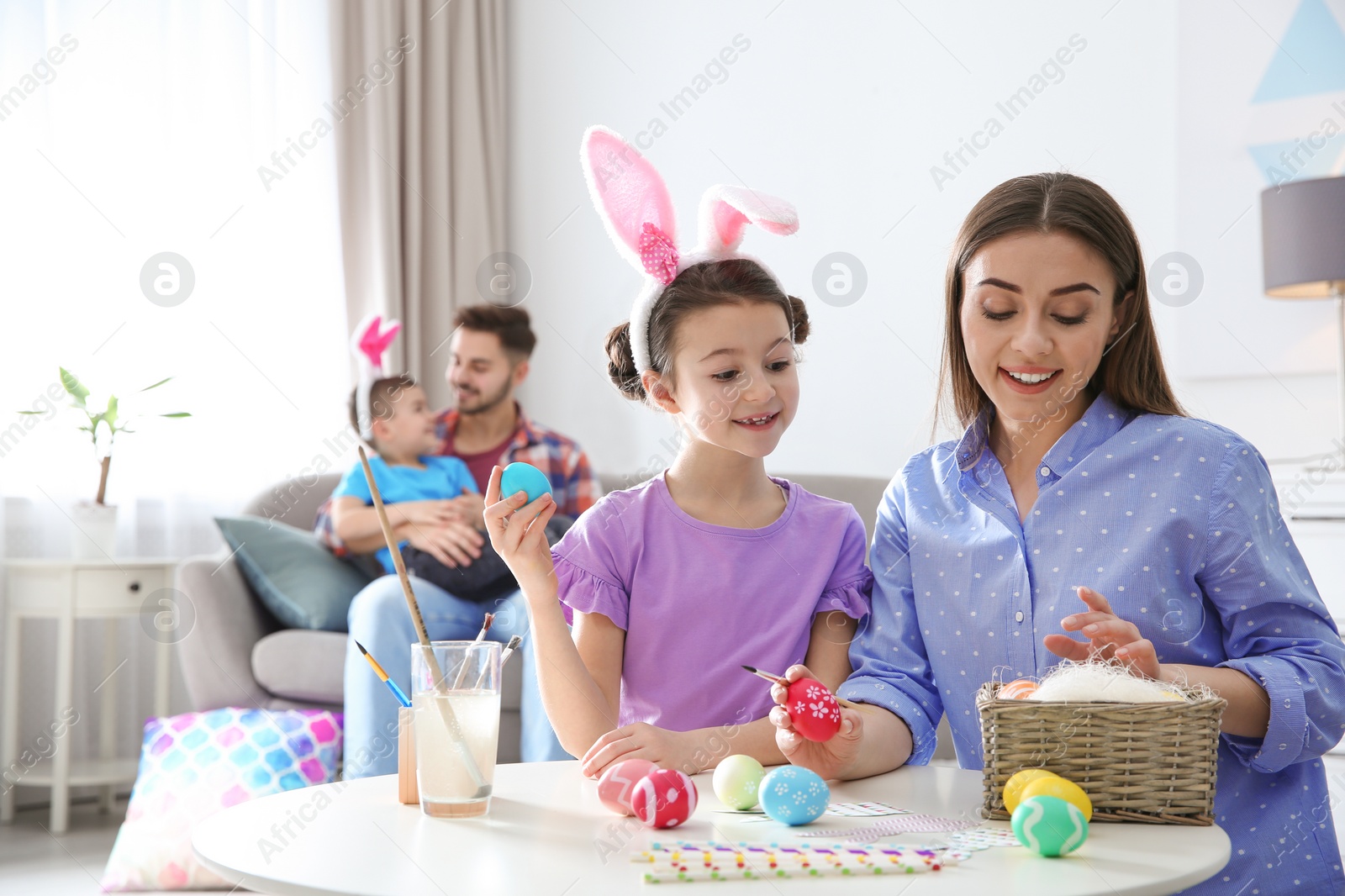 Photo of Happy family preparing for Easter holiday at home