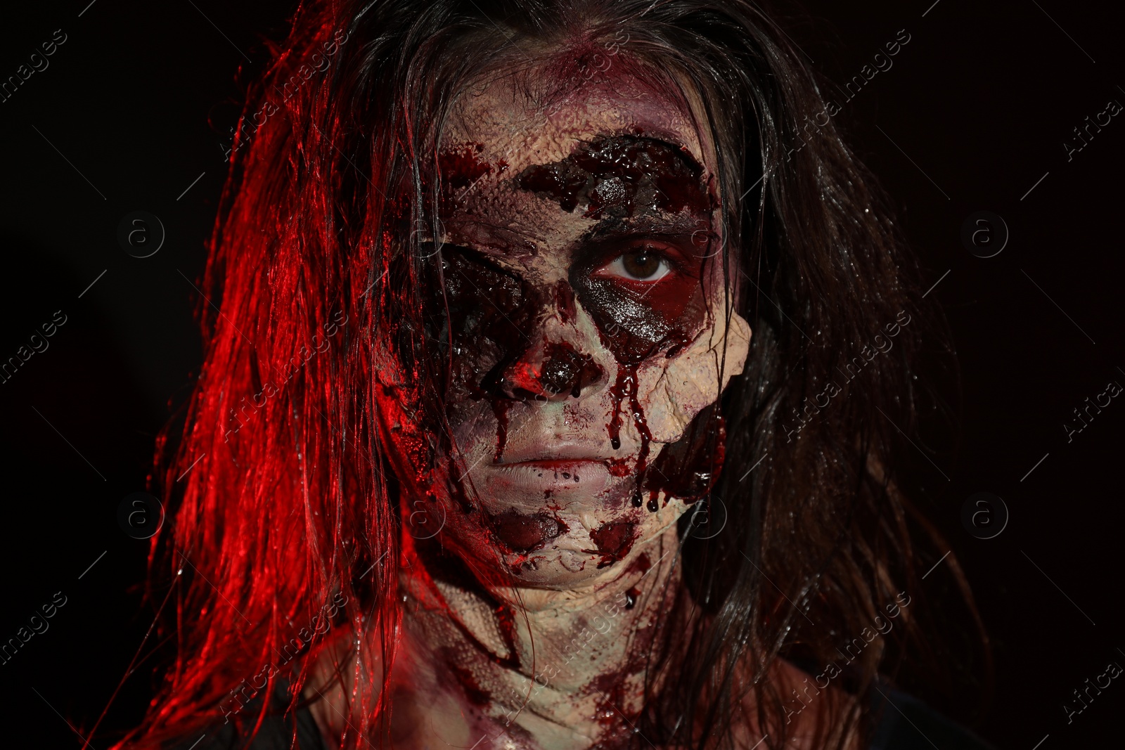 Photo of Scary zombie on dark background, closeup. Halloween monster