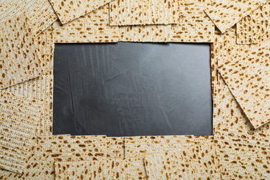 Photo of Frame of traditional matzos on grey table, flat lay. Space for text