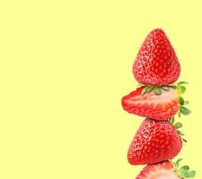 Image of Stack of fresh strawberries on light yellow background, space for text