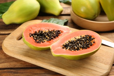 Fresh ripe papaya fruits on wooden table