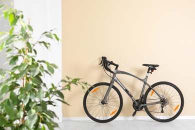 Photo of Modern apartment interior with bicycle near wall. Space for text