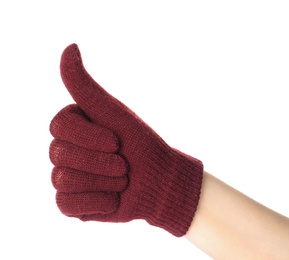 Woman in woolen glove showing thumb up gesture on white background, closeup. Winter clothes