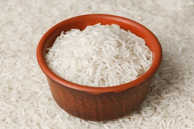 Photo of Raw basmati rice and bowl as background