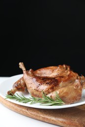 Photo of Tasty cooked rabbit meat with rosemary on white table, closeup. Space for text