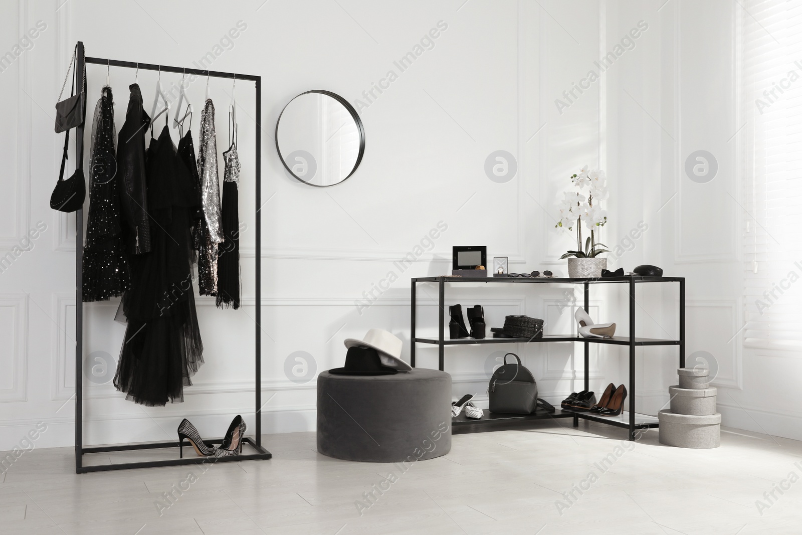 Photo of Stylish dressing room interior with trendy clothes, shoes and accessories