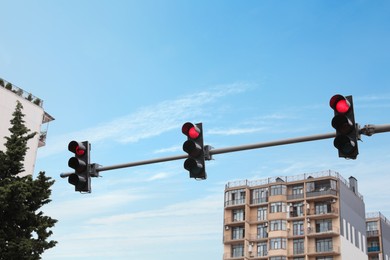 Modern traffic lights in city against cloudy sky