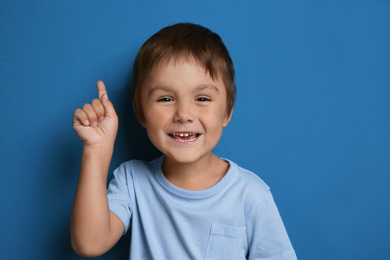 Photo of Portrait of happy little boy on blue background