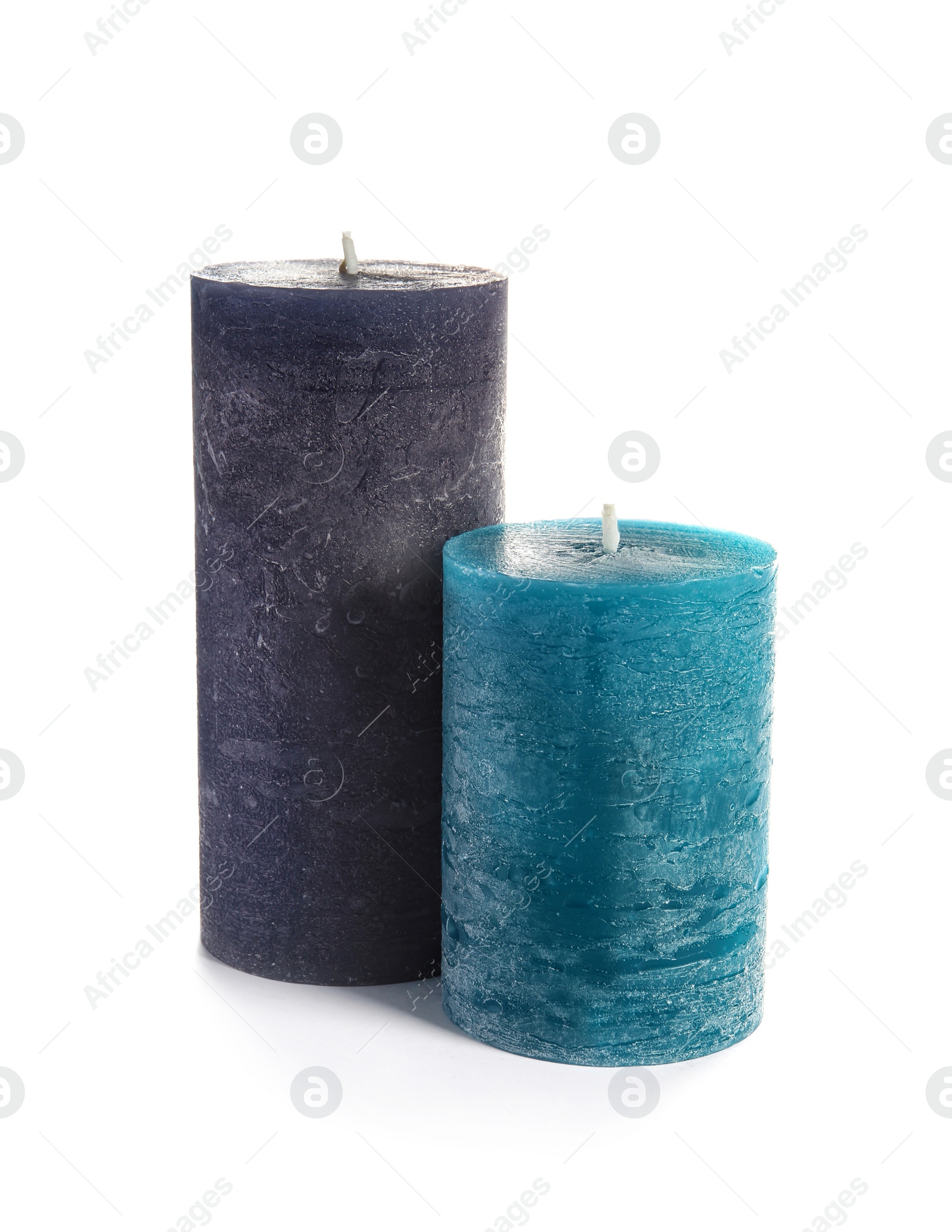 Photo of Two decorative wax candles on white background