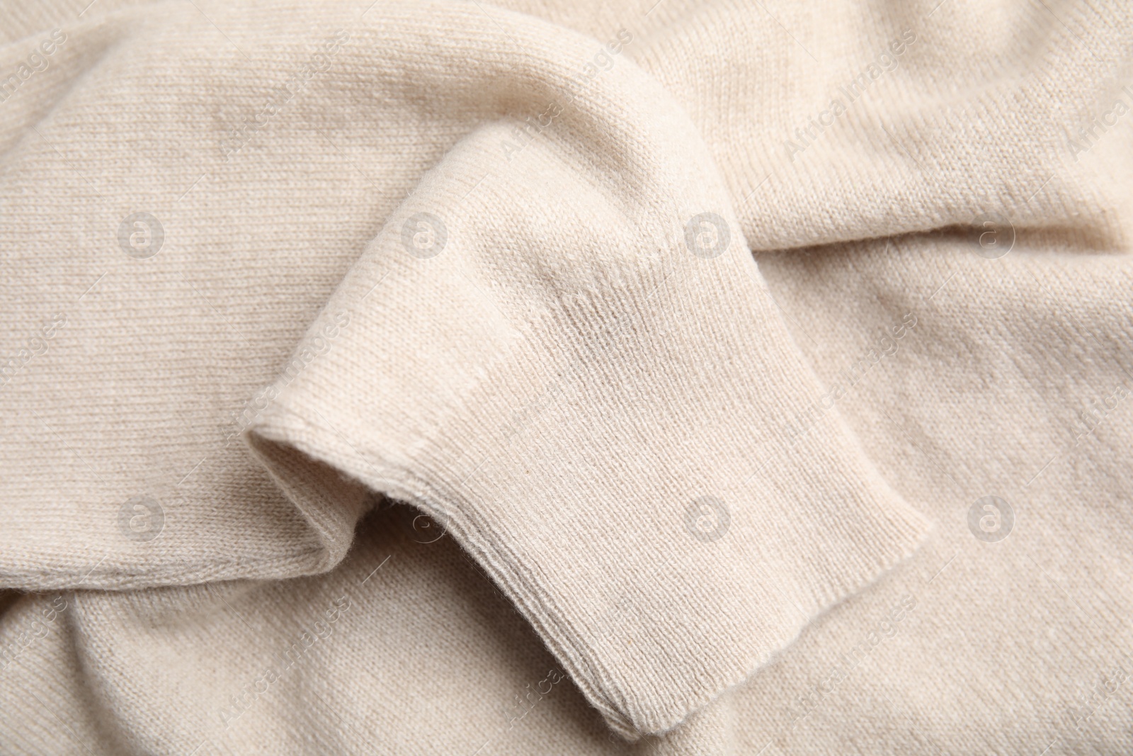 Photo of Warm cashmere sweater as background, closeup view