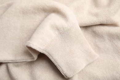 Warm cashmere sweater as background, closeup view