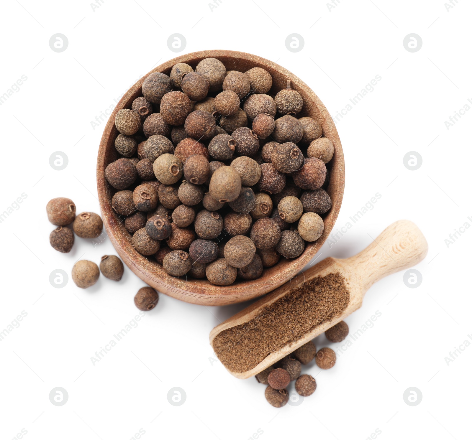 Photo of Ground and whole allspice berries (Jamaica pepper) isolated on white, top view