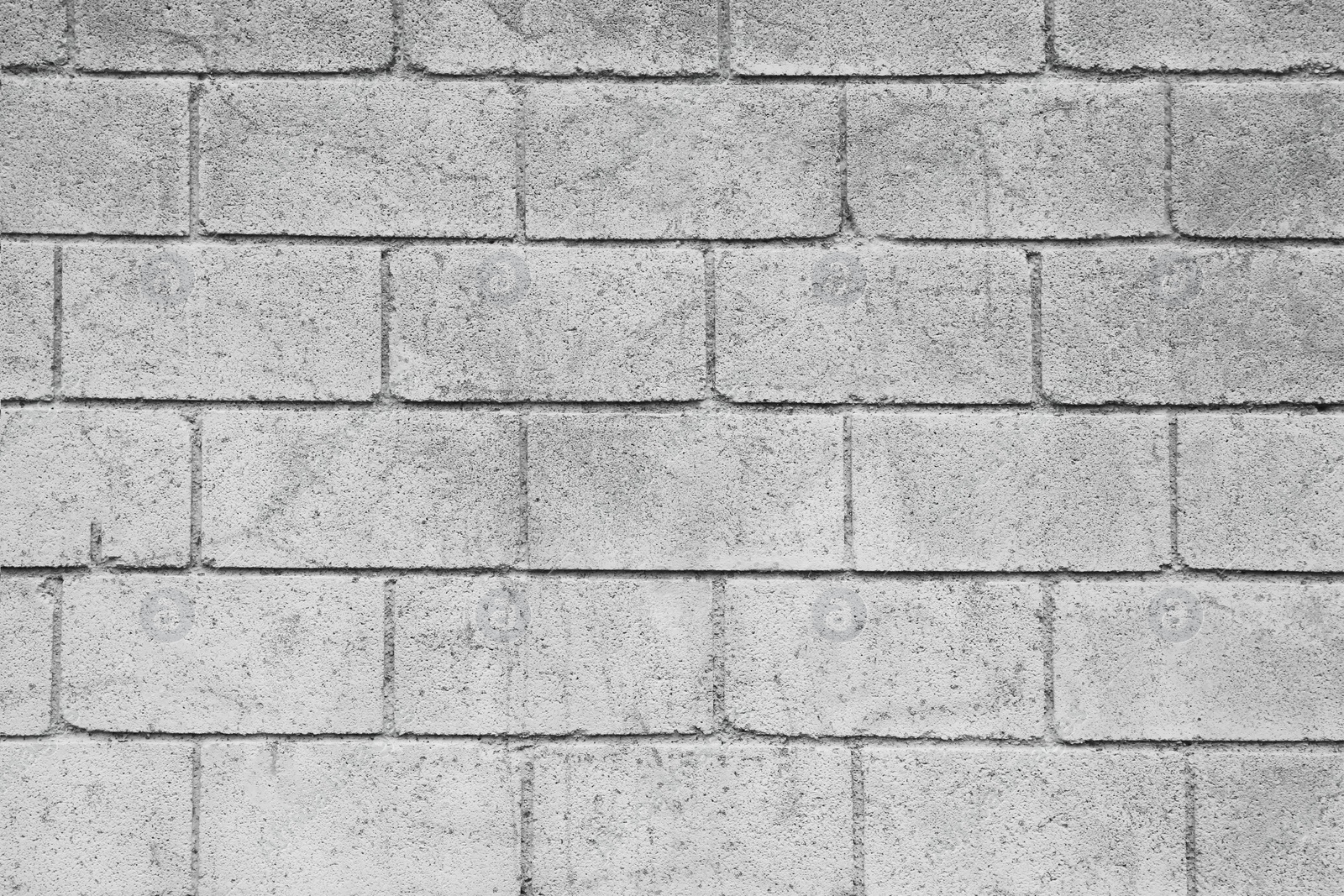 Photo of Texture of light grey brick wall as background