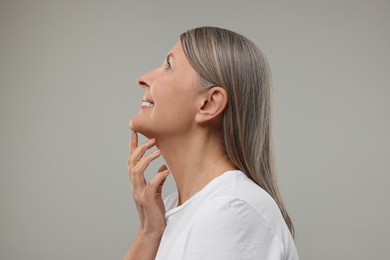 Photo of Beautiful woman with healthy skin on grey background