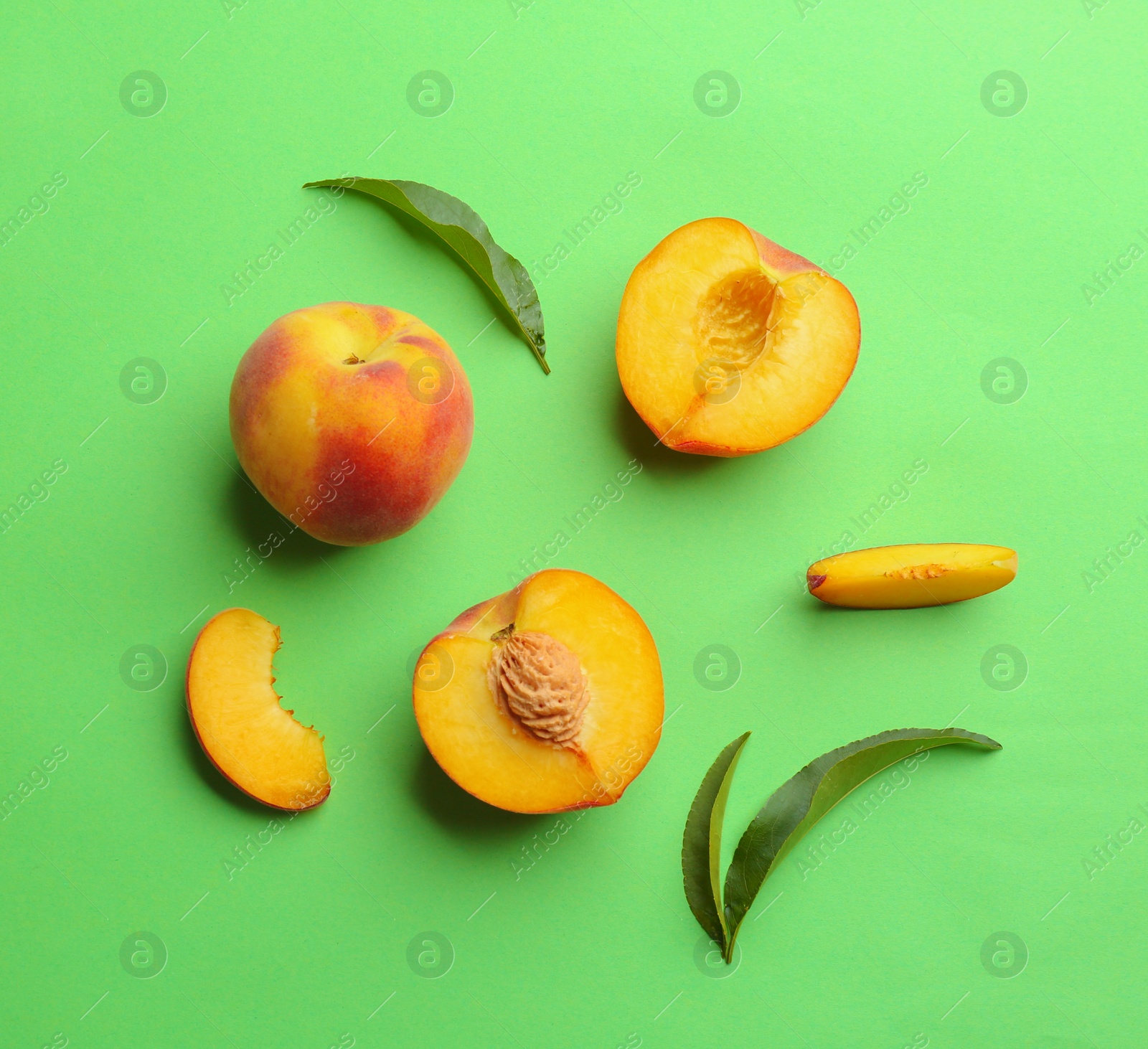 Photo of Flat lay composition with fresh peaches on green background