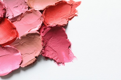 Photo of Collection of lipstick swatches on white background, top view