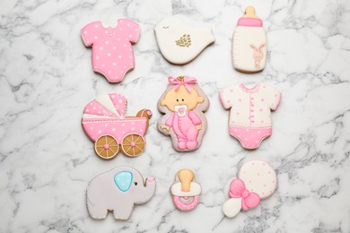 Set of baby shower cookies on white marble table, flat lay