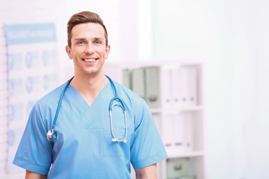 Photo of Portrait of medical assistant with stethoscope in hospital. Space for text