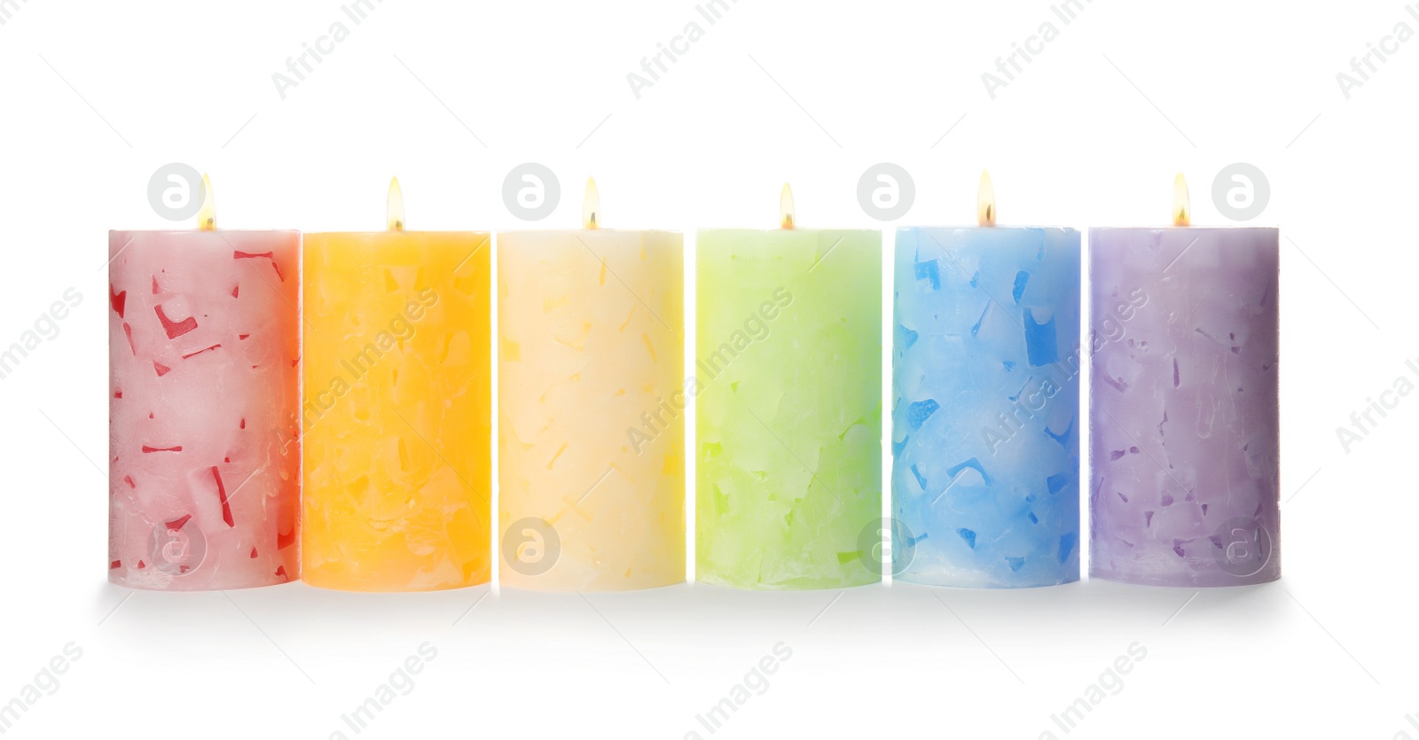 Photo of Alight color wax candles on white background