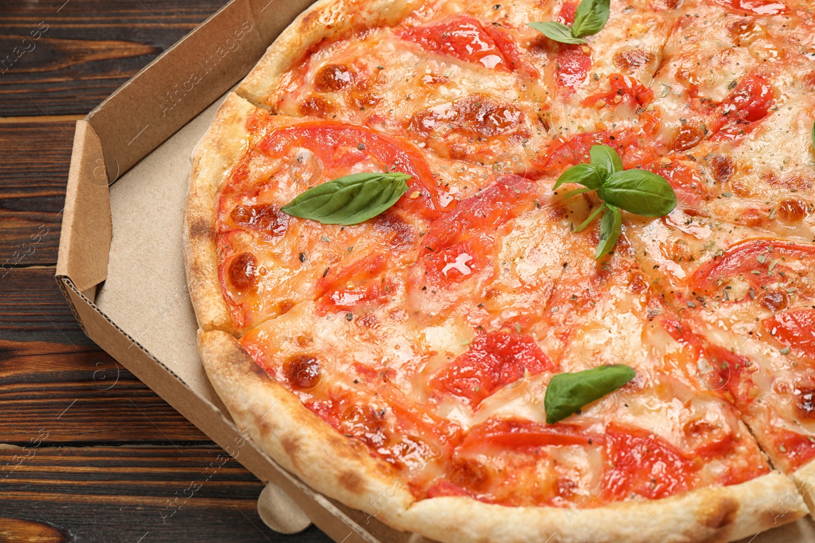 Photo of Delicious pizza Margherita on wooden table, closeup view