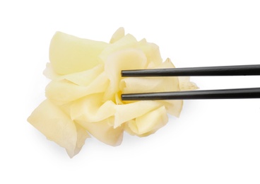 Chopsticks with pickled ginger on white background, top view