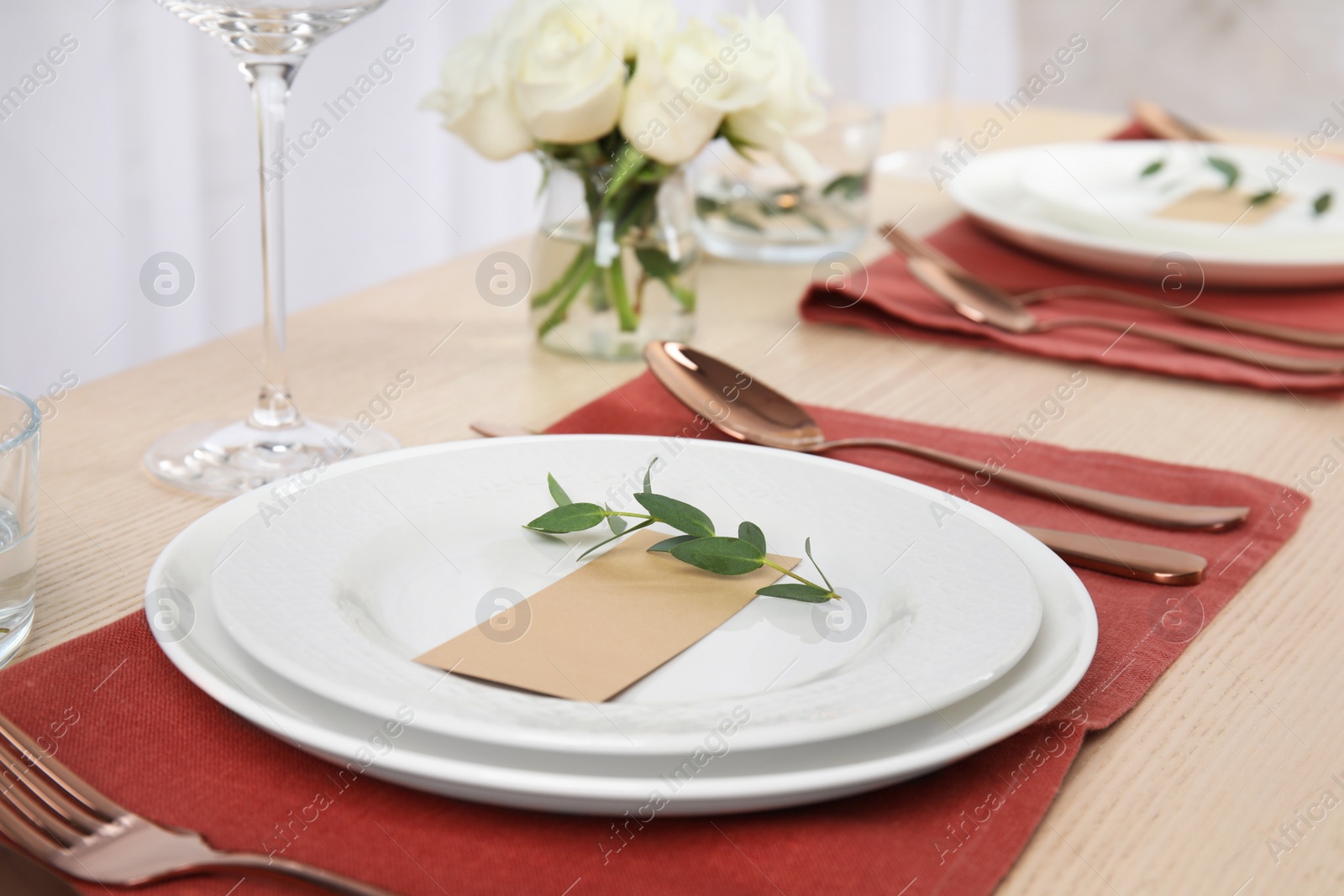 Photo of Elegant festive table setting with blank card in restaurant