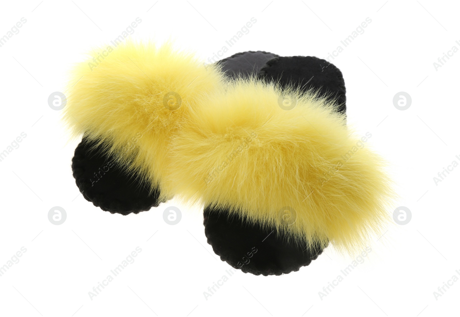 Photo of Pair of soft open toe slippers with yellow fur on white background