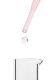 Dripping liquid from pipette into beaker on white background, closeup
